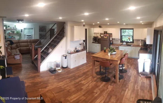 a view of a dining room with furniture wooden floor and a rug