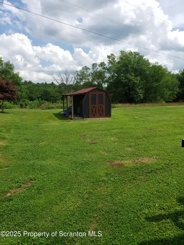 a backyard of a house with lots of green space