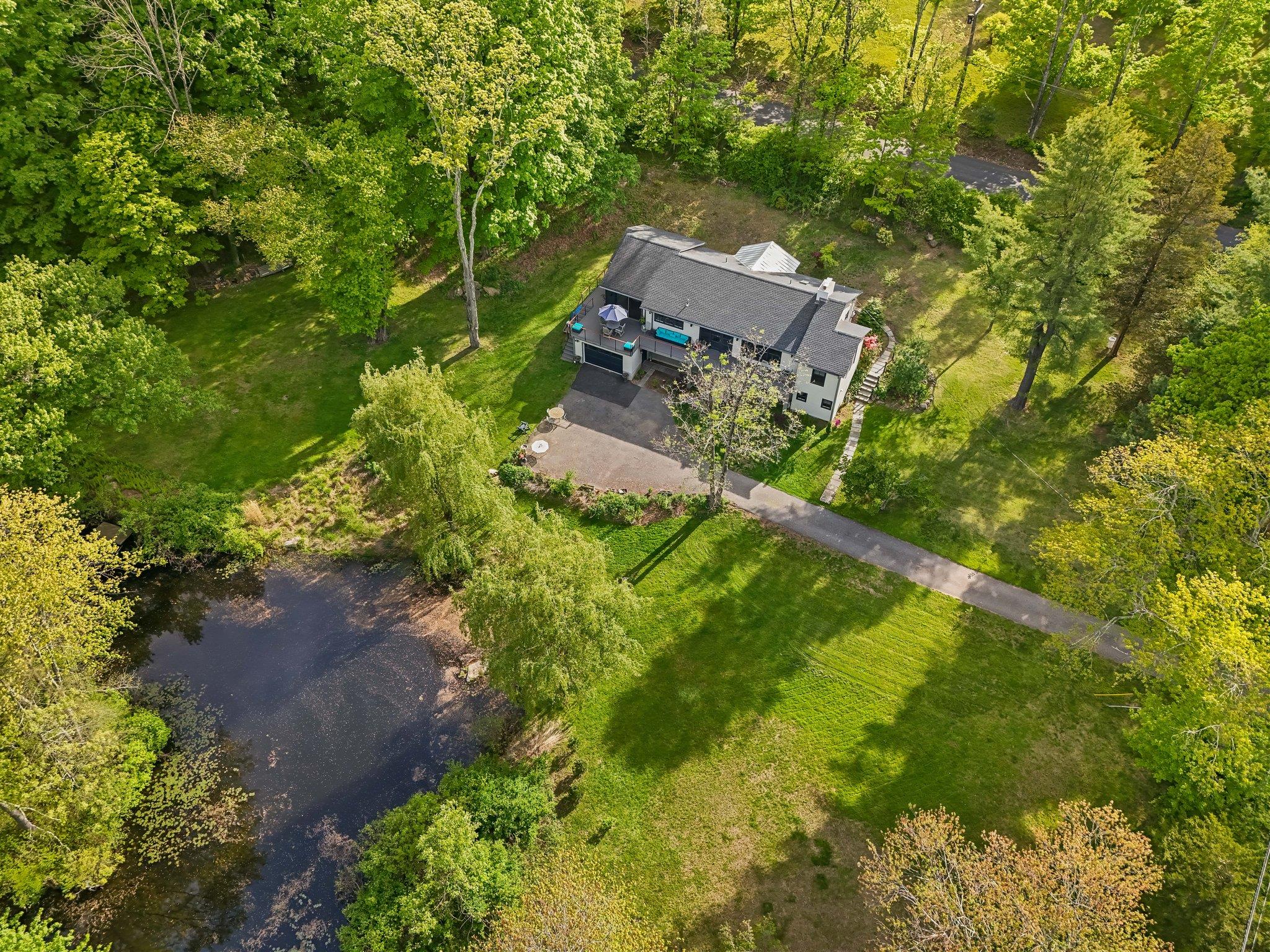 119 Cross Pond Road Pound Ridge, NY 10576 - Photo 1 of 1 an aerial view of a house with a yard