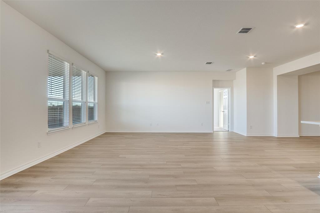 329 Fallbrook Drive Aledo, TX 76008 - Photo 7 of 33 a view of an empty room with wooden floor and a window