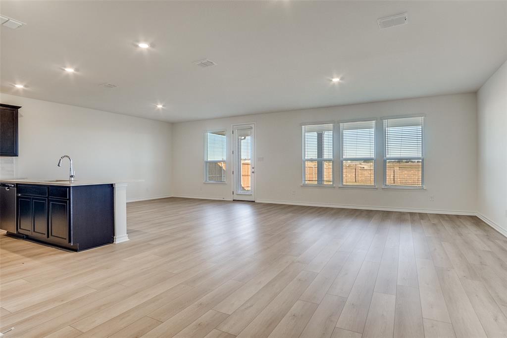 329 Fallbrook Drive Aledo, TX 76008 - Photo 8 of 33 an empty room with wooden floor and windows