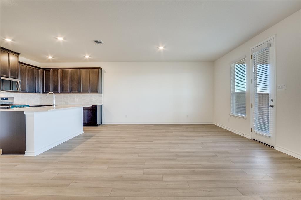 329 Fallbrook Drive Aledo, TX 76008 - Photo 9 of 33 a view of kitchen with kitchen island wooden floor center island and stainless steel appliances with cabinets