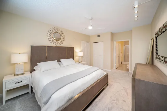 a bedroom with a large bed and a chandelier