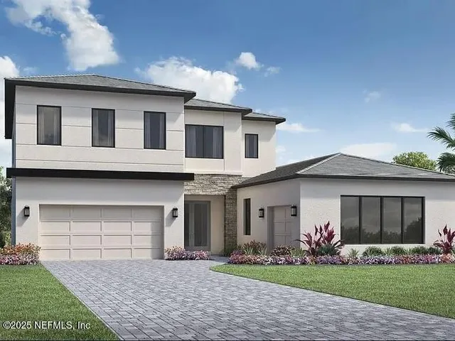 a front view of a house with a garden and yard