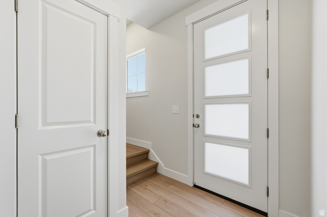 7338 South Seven Tree Lane, Unit 75 Midvale, UT 84047 - Photo 5 of 30 Doorway featuring wood finished floors and baseboards