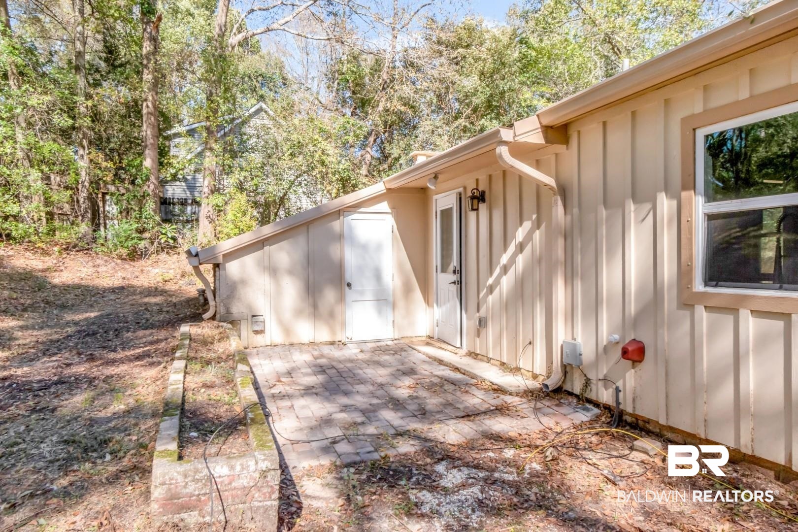410 St John Place Mobile, AL 36609 - Photo 31 of 32 Doorway to property with board and batten siding and a patio