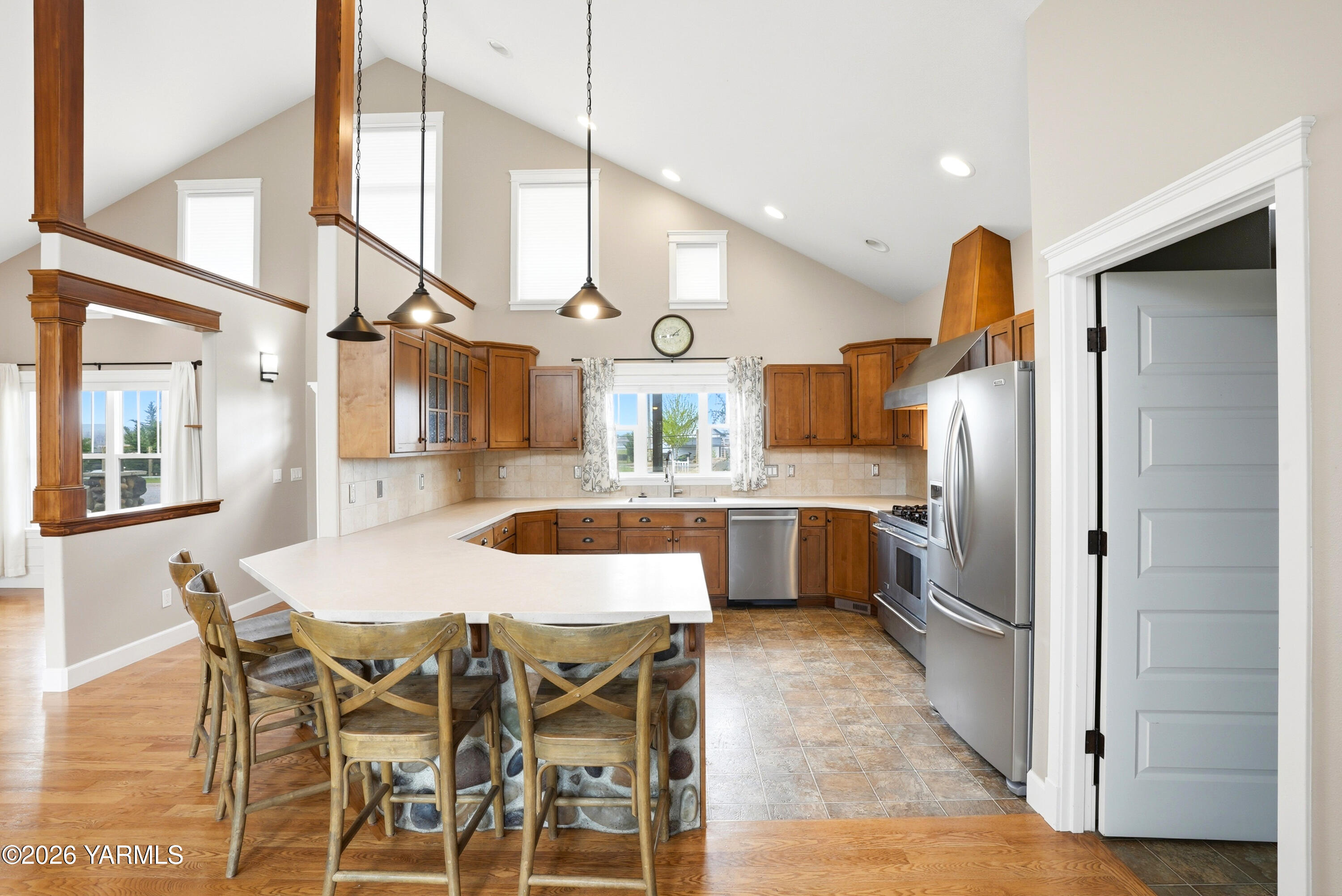 230 Albro Road Sunnyside, WA 98944 - Photo 9 of 46 a kitchen with stainless steel appliances kitchen island granite countertop a table chairs and a refrigerator