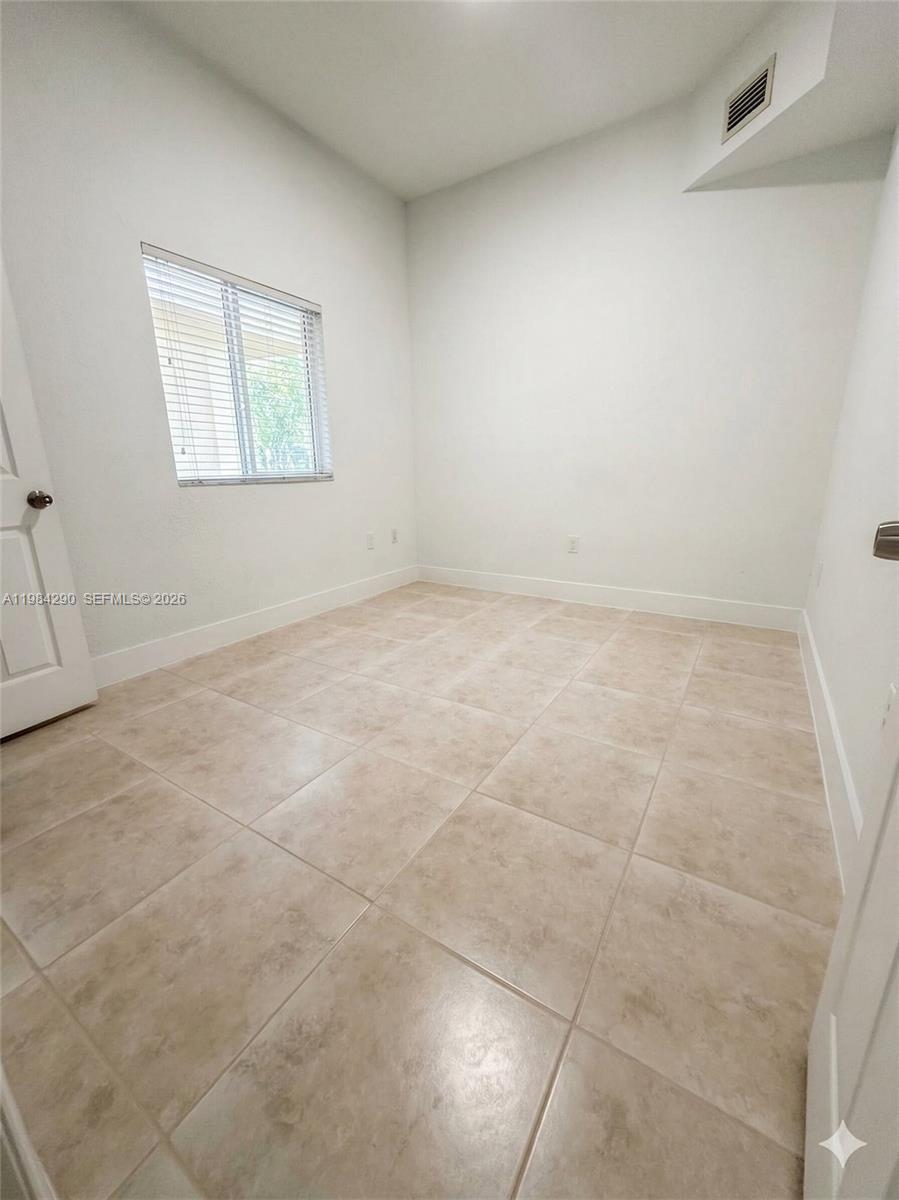 2801 Riverside Drive, Unit 204 Coral Springs, FL 33065 - Photo 11 of 20 a view of an empty room with a window