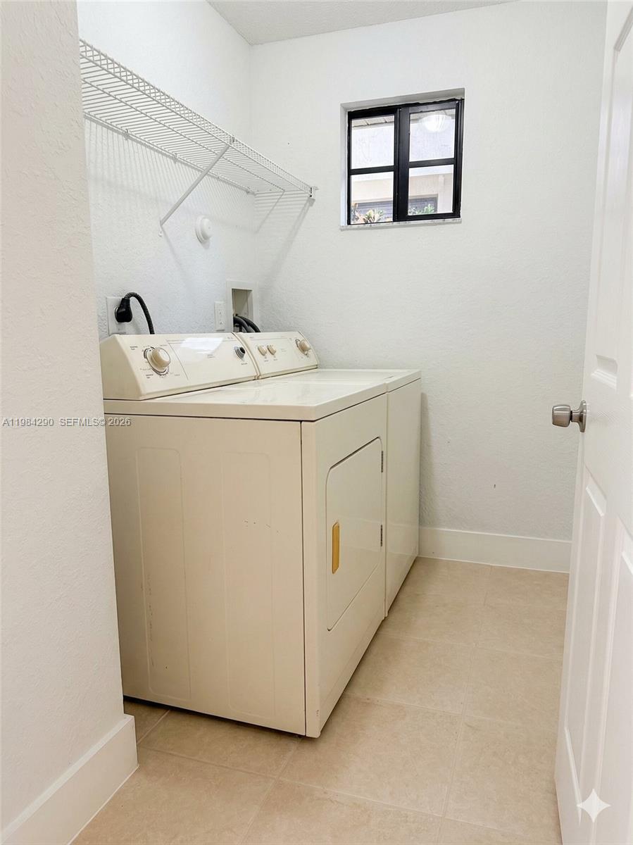 2801 Riverside Drive, Unit 204 Coral Springs, FL 33065 - Photo 13 of 20 a utility room with dryer and washer