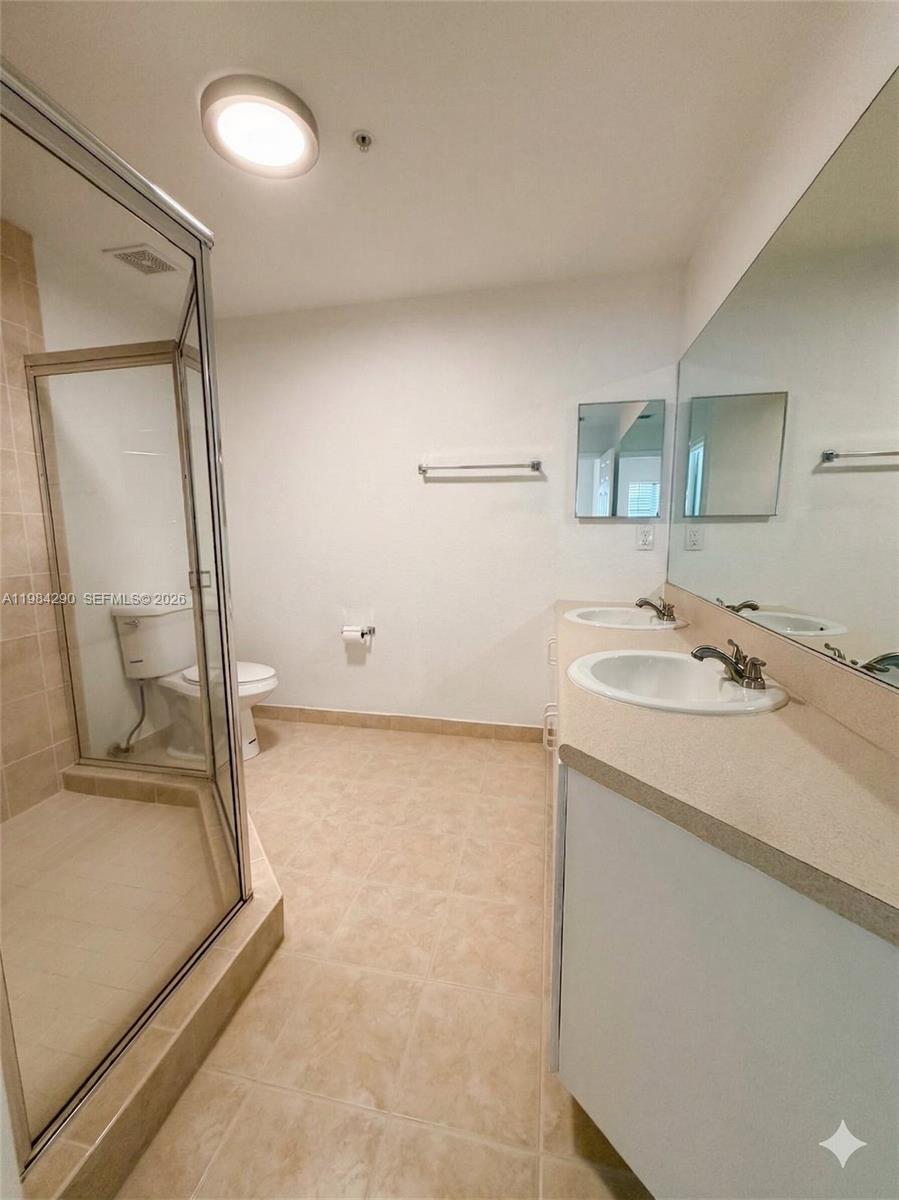 2801 Riverside Drive, Unit 204 Coral Springs, FL 33065 - Photo 16 of 20 a bathroom with a sink and a mirror