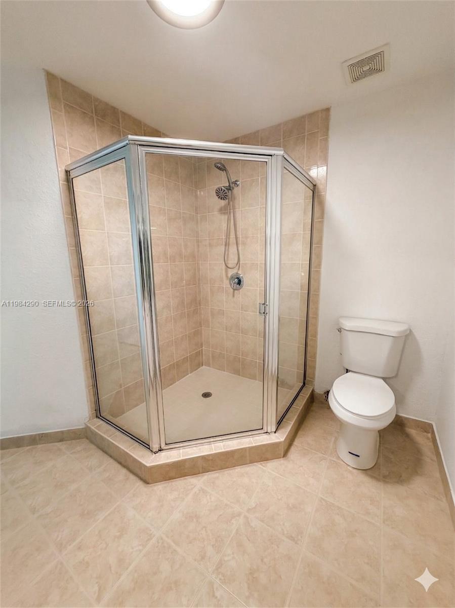 2801 Riverside Drive, Unit 204 Coral Springs, FL 33065 - Photo 17 of 20 a bathroom with a shower and a toilet