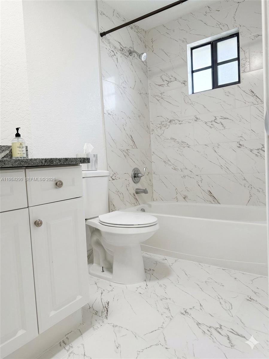 2801 Riverside Drive, Unit 204 Coral Springs, FL 33065 - Photo 8 of 20 a bathroom with a toilet sink and shower