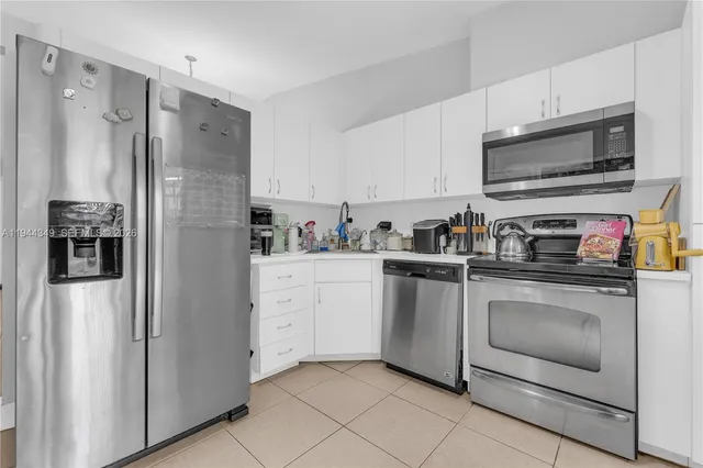 a kitchen with stainless steel appliances a refrigerator stove and microwave