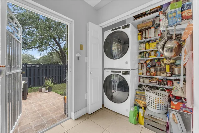 a view of a hallway with washer and dryer next to a window