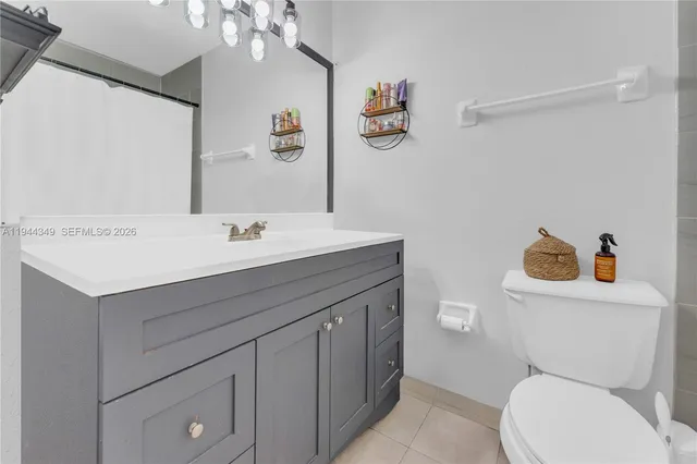 a bathroom with a sink mirror vanity and toilet