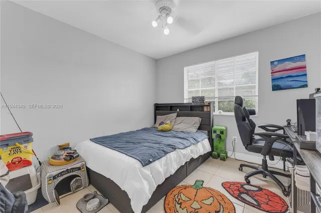 a bedroom with bed and a window