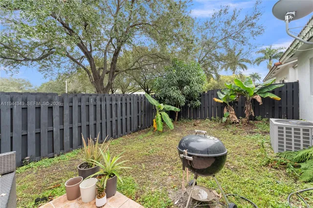 a backyard of a house with table and chairs