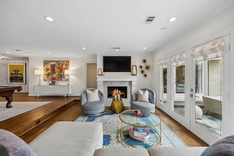 a living room with furniture a fireplace and a flat screen tv