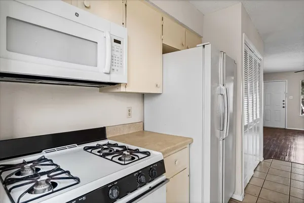 a kitchen with a stove and a microwave