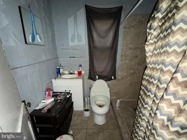 a bathroom with a toilet and a mirror