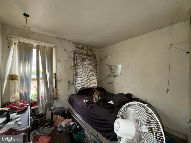 a couple of white chairs sitting next to a window