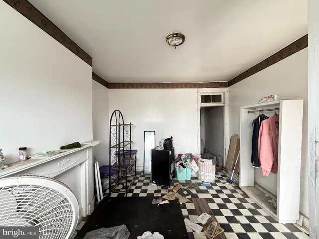 a bedroom with a bed and dresser with mirror