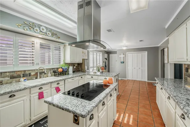 a kitchen that has a lot of cabinets in it and appliances