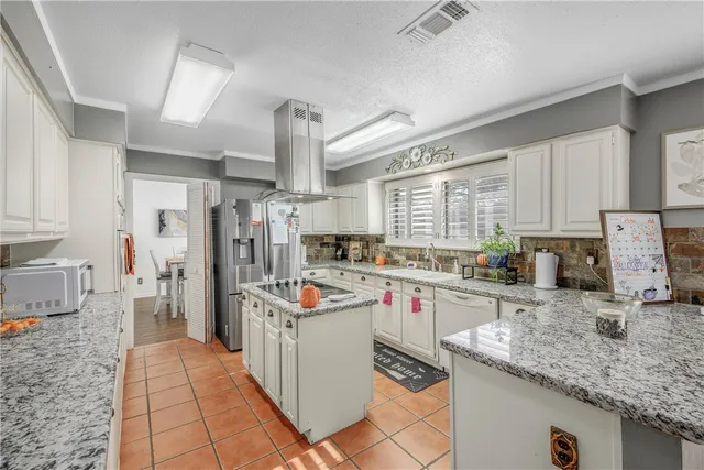 a kitchen with stainless steel appliances granite countertop a sink and cabinets