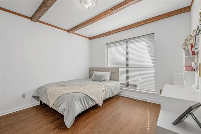 a bedroom with a large bed and a chandelier