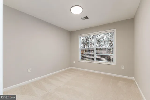 an empty room with a empty space and windows