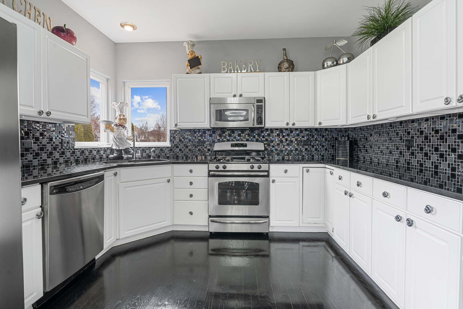 24962 Ambrose Road Plainfield, IL 60585 - Photo 14 of 28 a kitchen with granite countertop white cabinets and white appliances