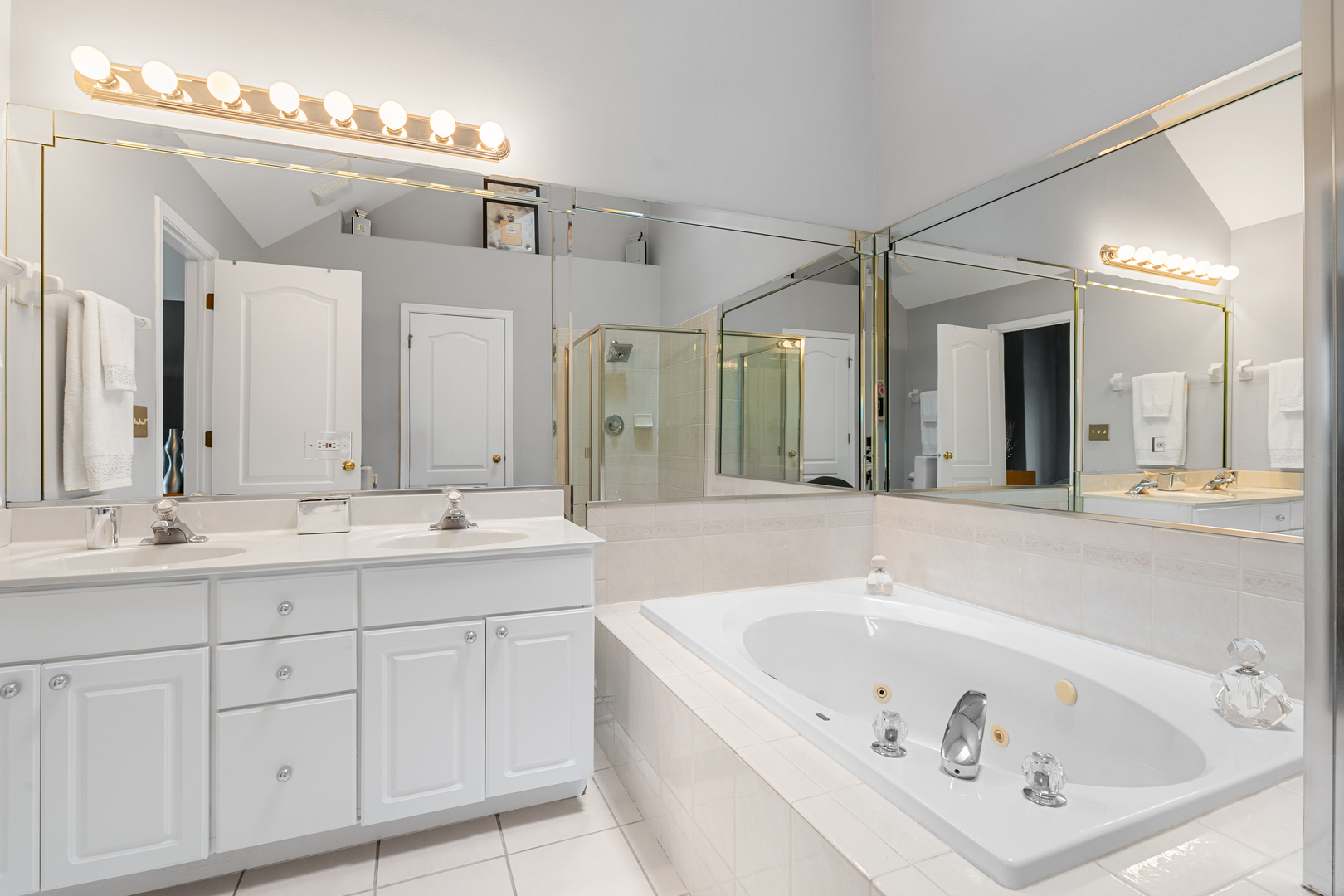 24962 Ambrose Road Plainfield, IL 60585 - Photo 24 of 28 a bathroom with a bathtub a double vanity sink and mirror