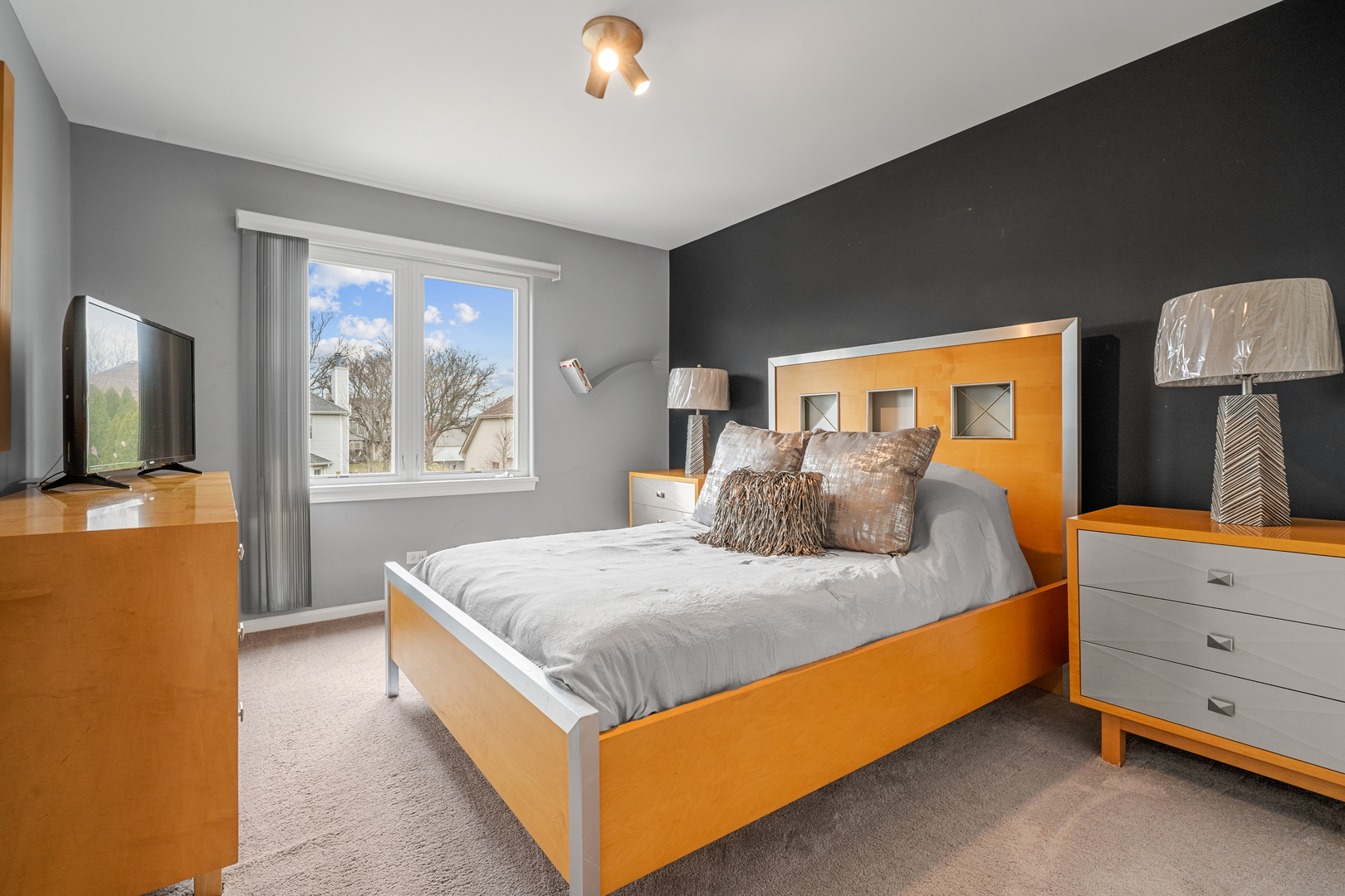 24962 Ambrose Road Plainfield, IL 60585 - Photo 25 of 28 a bed room with a bed and a tv