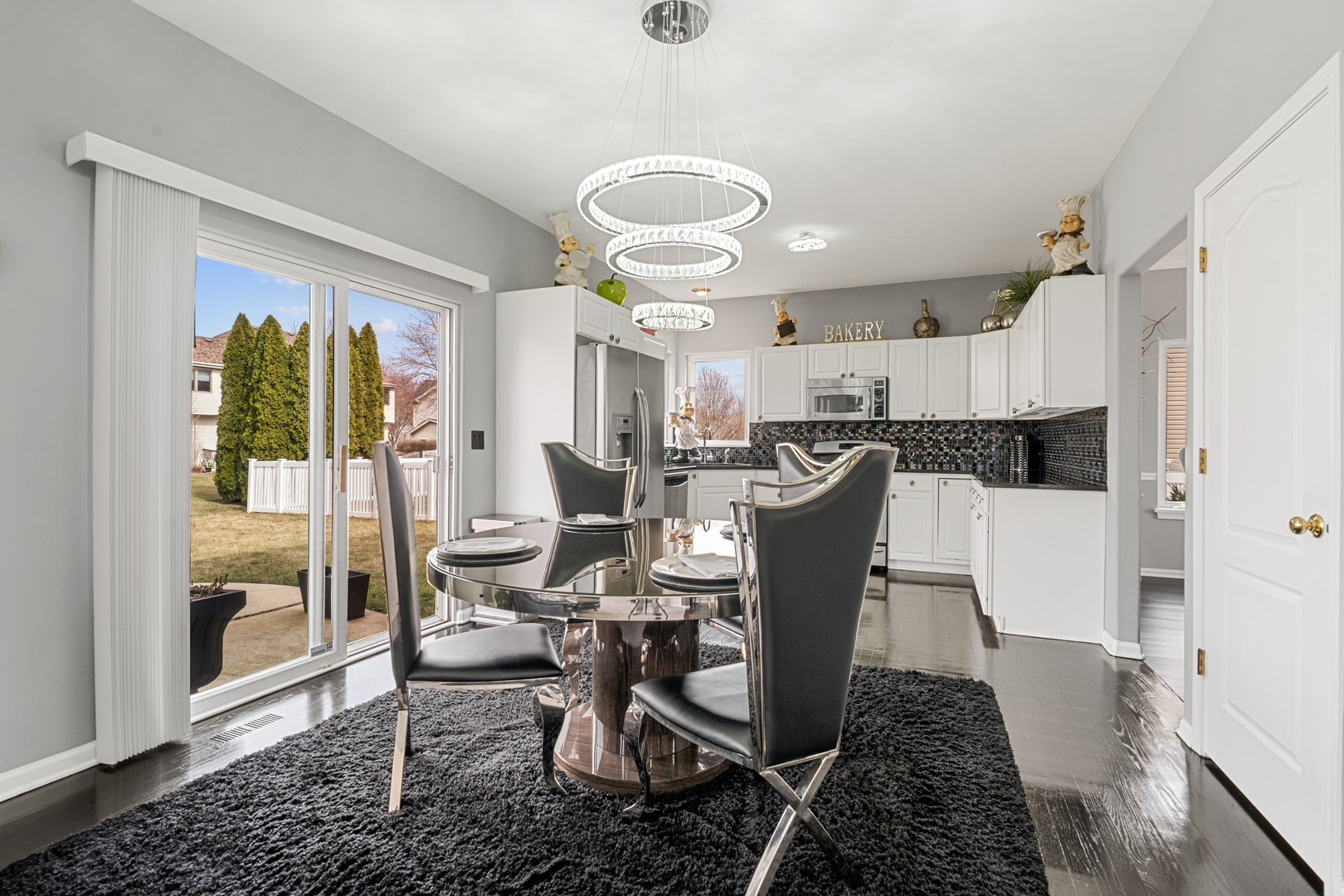 24962 Ambrose Road Plainfield, IL 60585 - Photo 10 of 28 a view of a dining room with furniture window and wooden floor
