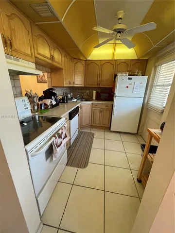 a kitchen with a sink a stove and cabinets