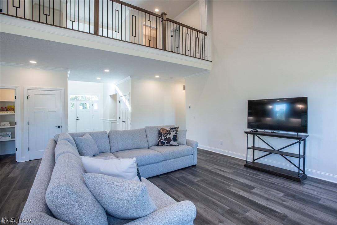 34286 Brookside Lane North Ridgeville, OH 44039 - Photo 10 of 50 Living room featuring a towering ceiling, dark wood-style flooring, and recessed lighting