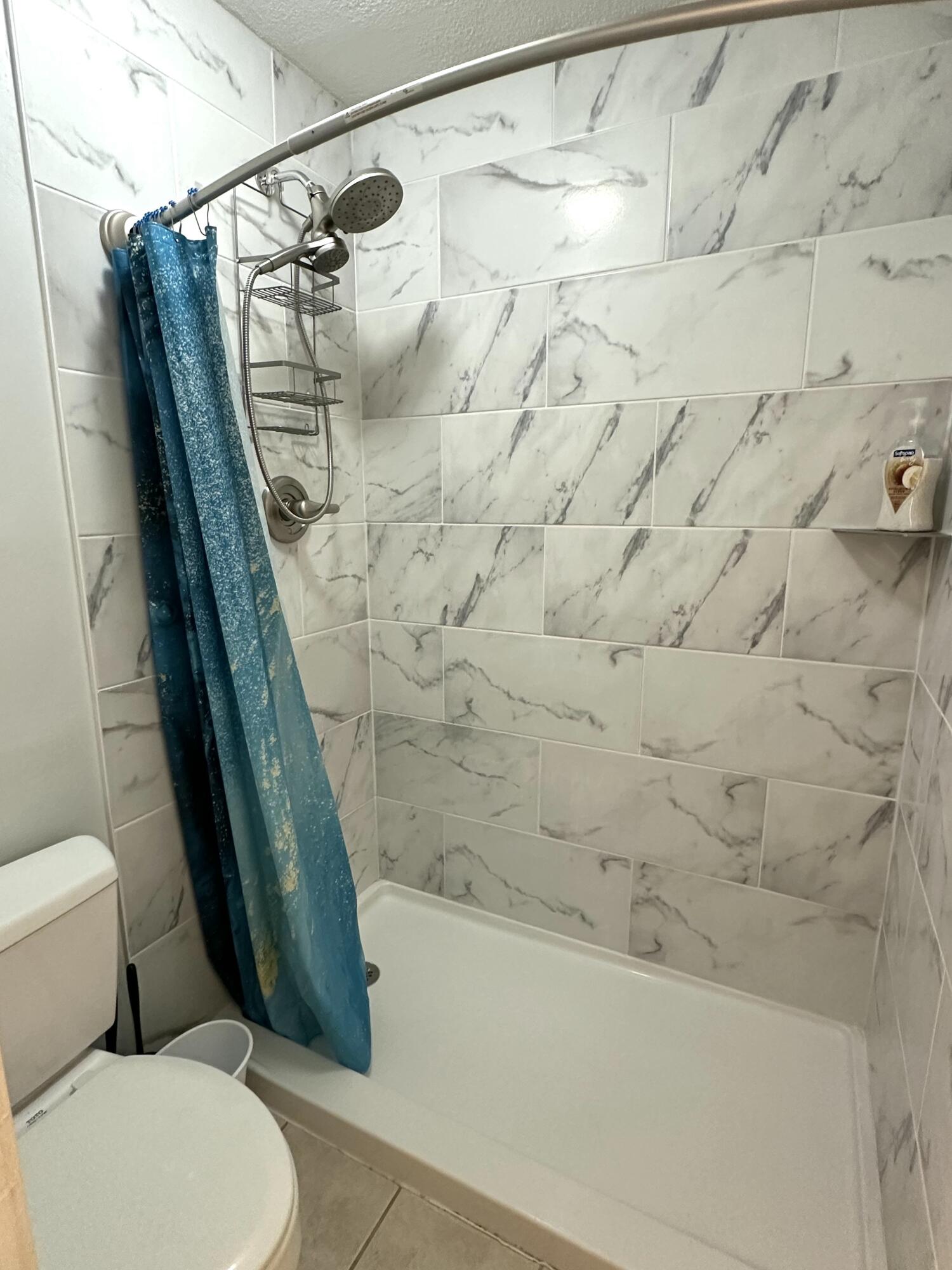 210 Pelham Road, Unit 208C Fort Walton Beach, FL 32547 - Photo 9 of 13 a bathroom with a toilet and a shower