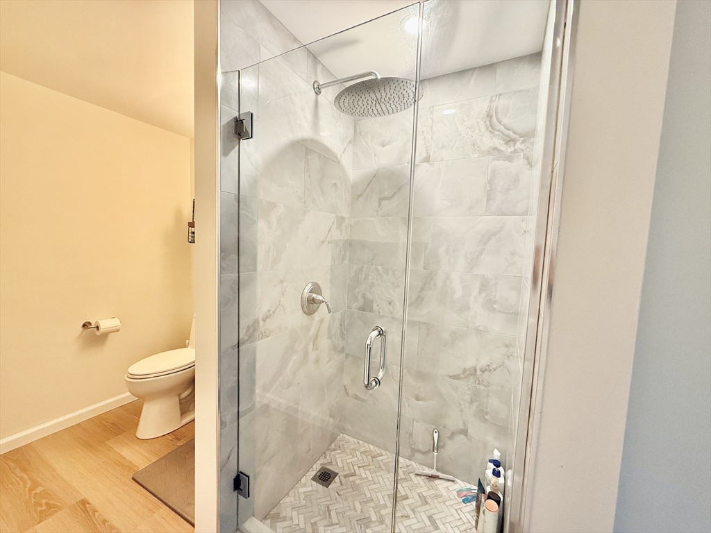20 Stearns Road, Unit 45 Brookline, MA 02446 - Photo 12 of 22 a bathroom with a shower and a toilet