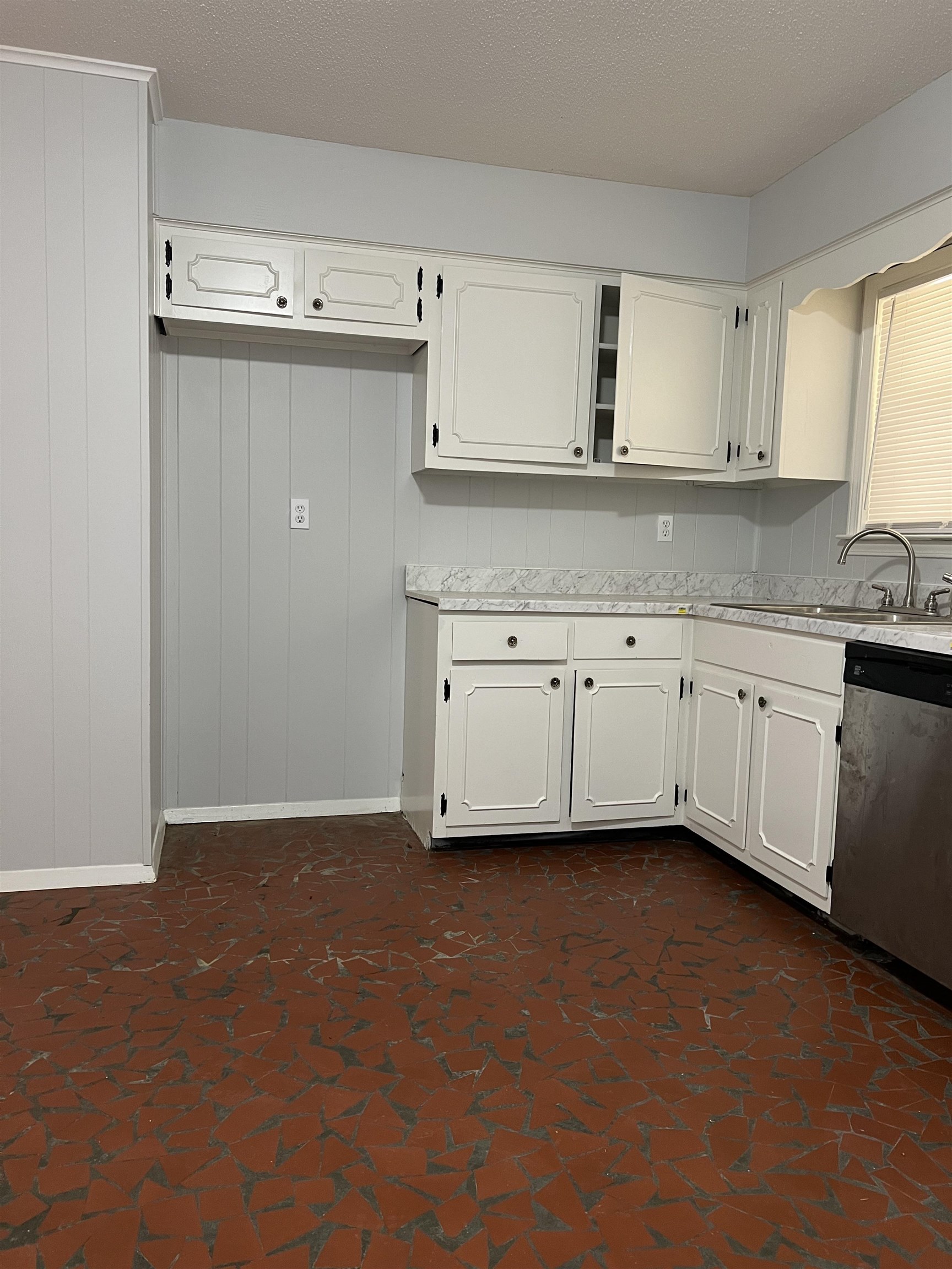 1106 Star Line Road Memphis, TN 38109 - Photo 8 of 16 Kitchen featuring dishwasher, white cabinets, sink, and a textured ceiling