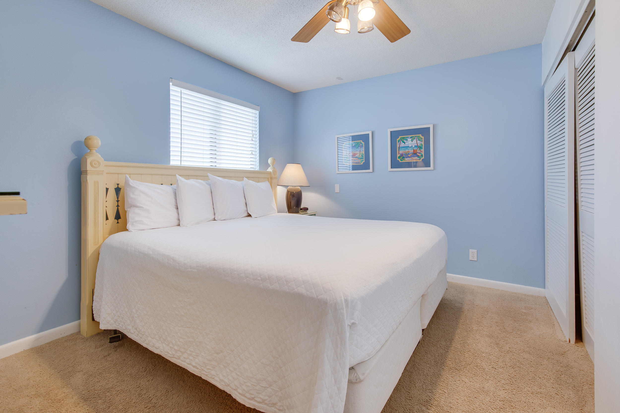 214 Blue Mountain Road, Unit 124 Santa Rosa Beach, FL 32459 - Photo 16 of 30 a bedroom with a bed and a chandelier