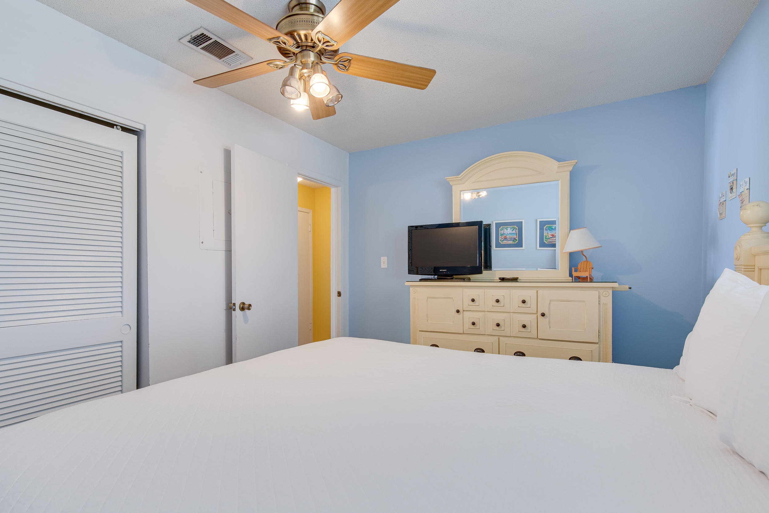 214 Blue Mountain Road, Unit 124 Santa Rosa Beach, FL 32459 - Photo 17 of 30 a bedroom with a bed and a flat screen tv