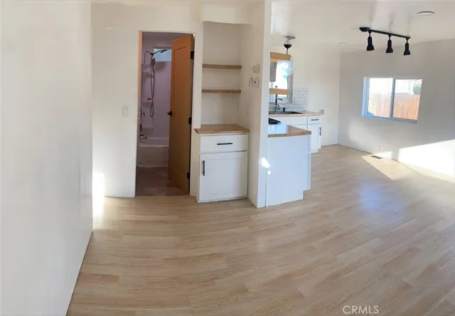 a view of a kitchen cabinets and wooden floor