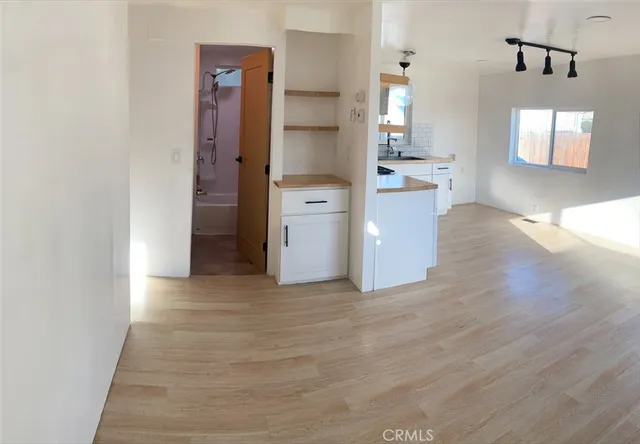 a view of a kitchen cabinets and wooden floor