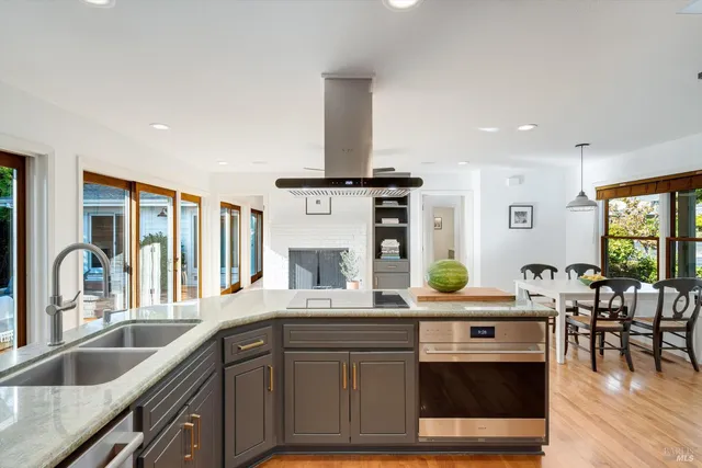 a kitchen with stainless steel appliances granite countertop a sink and a wooden cabinets