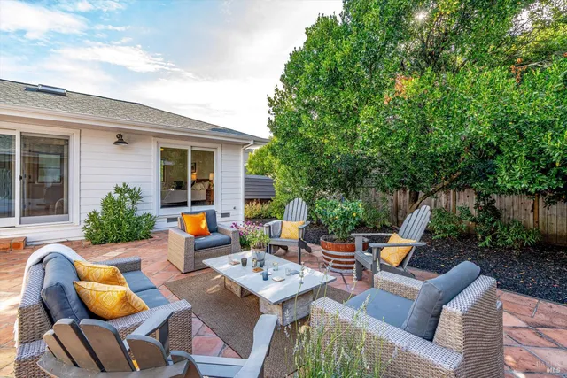 a view of backyard of house with seating area