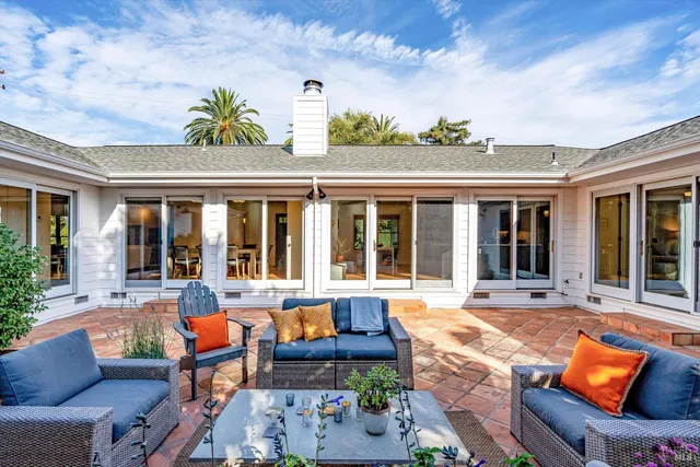 front view of a house with a lounge chair