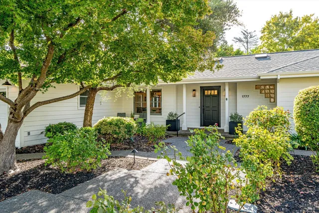 a front view of a house with garden