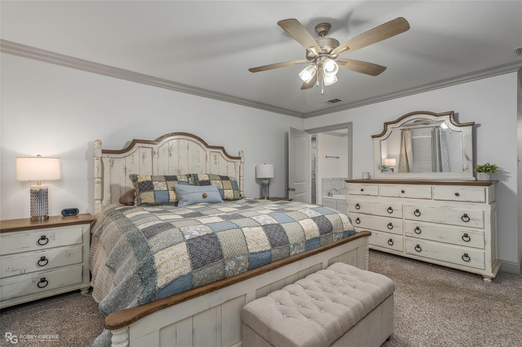 396 Collinswood Road Stonewall, LA 71078 - Photo 27 of 32 a bedroom with a bed and a dresser