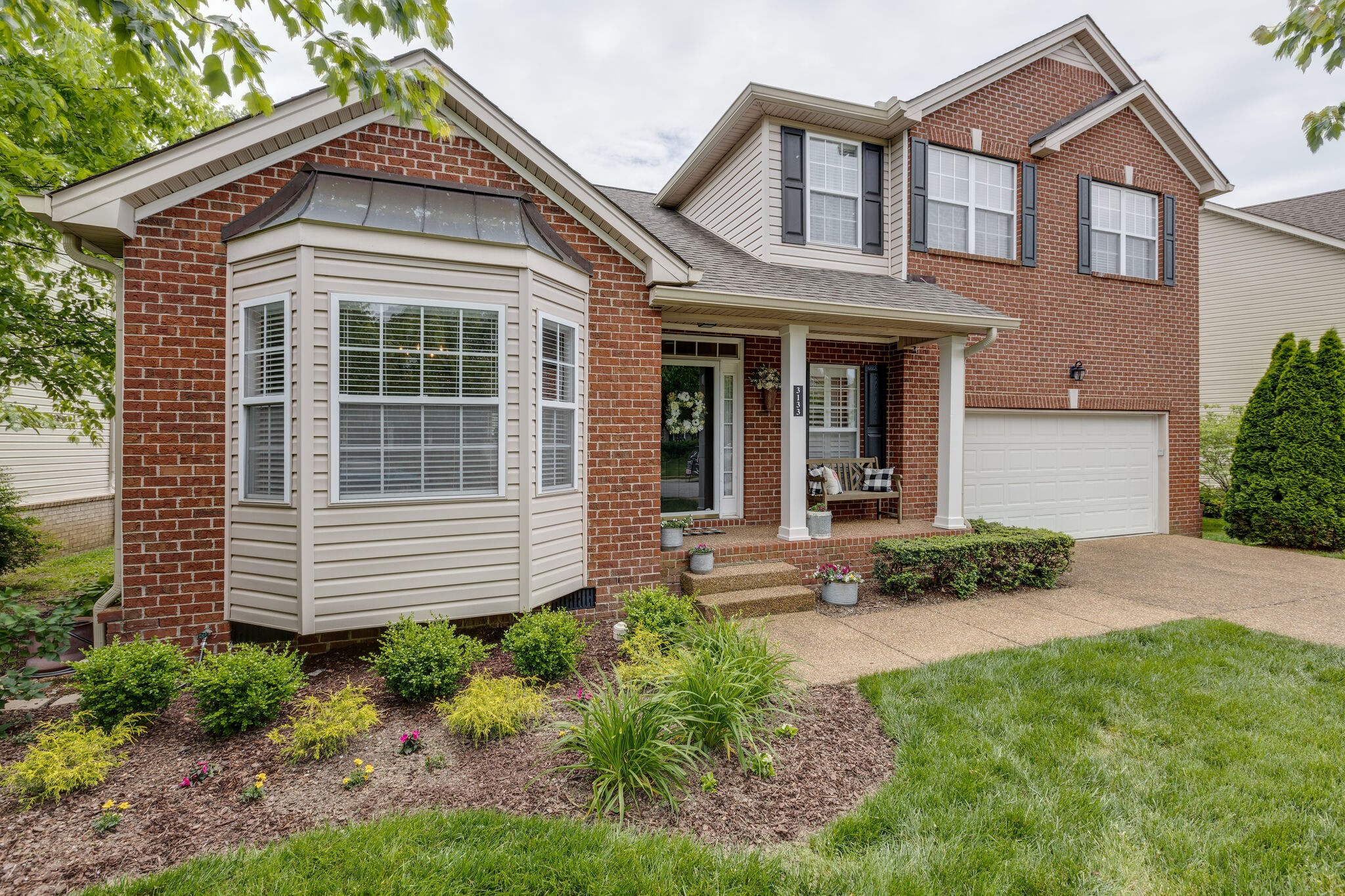 3133 Brimstead Drive Franklin, TN 37064 - Photo 2 of 32 a front view of a house with a yard and outdoor seating