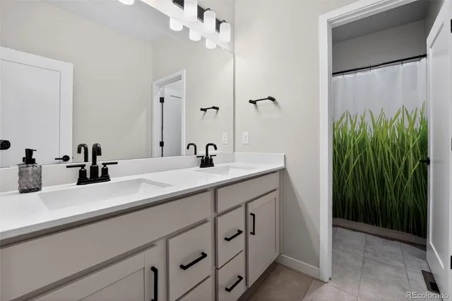 a bathroom with a double vanity sink and a mirror